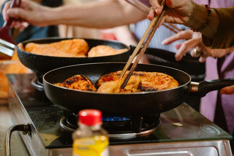 Wing Snob team preparing hot chicken in the kitchen