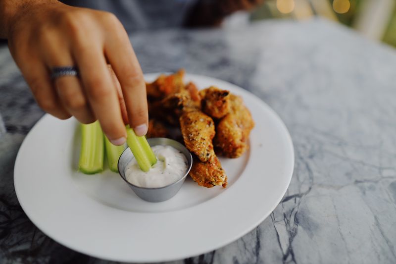 Fresh chicken preparation at Wing Snob kitchen